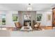 Cozy living room with fireplace, modern decor, wood floors, and large windows at 3666 S Jersey St, Denver, CO 80237