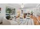 Inviting living room featuring a plush sofa, stylish lighting, and expansive windows that flood the space with natural light at 3666 S Jersey St, Denver, CO 80237