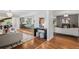 Open-concept living room with hardwood floors, designer lighting, and seamless flow to the kitchen and dining areas at 3666 S Jersey St, Denver, CO 80237