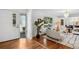 Bright and airy living room featuring hardwood floors, a stylish sofa, and large windows offering scenic views at 3666 S Jersey St, Denver, CO 80237