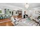 Spacious living area with seamless transition to kitchen, dining, and living spaces with hardwood flooring and natural light at 3666 S Jersey St, Denver, CO 80237