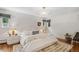 Airy main bedroom features a modern chandelier, hardwood floors, and bright natural light at 3666 S Jersey St, Denver, CO 80237