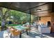 Covered patio with wicker seating area and a glass top dining table and chairs at 3666 S Jersey St, Denver, CO 80237