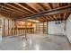 Unfinished basement with exposed wood ceiling, concrete floor, and built in shelving at 3666 S Jersey St, Denver, CO 80237