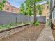 A patio featuring a stone wall and greenery, providing a tranquil outdoor space at 1050 N Corona St # 105, Denver, CO 80218