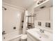 Bright, clean bathroom featuring a shower and tub combination with white tile and a modern sink at 1050 N Corona St # 105, Denver, CO 80218