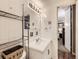 Compact bathroom featuring a white vanity and tile, accented by a metal shelving unit at 1050 N Corona St # 105, Denver, CO 80218