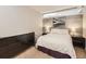 Cozy bedroom with wood accent wall and soft lighting creating a warm and inviting space at 1050 N Corona St # 105, Denver, CO 80218