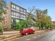 Contemporary apartment complex with large windows and brick accents, complemented by lush greenery at 1050 N Corona St # 105, Denver, CO 80218