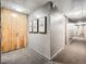 Apartment hallway with neutral carpet and paint, enhanced with tasteful artwork at 1050 N Corona St # 105, Denver, CO 80218