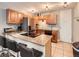 Kitchen featuring an island with breakfast bar, stainless steel appliances, and ample cabinet space at 1050 N Corona St # 105, Denver, CO 80218