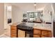 Well-appointed kitchen overlooking the living room, featuring an electric stove and granite countertops at 1050 N Corona St # 105, Denver, CO 80218