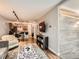Open-concept living room with hardwood floors and modern lighting, flowing into the kitchen at 1050 N Corona St # 105, Denver, CO 80218