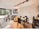 Living and dining area featuring hardwood floors, a modern lighting fixture, and comfortable seating at 1050 N Corona St # 105, Denver, CO 80218