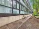 Exterior patio with brick accents and mature trees. Seating for two at 1050 N Corona St # 105, Denver, CO 80218