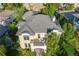 Aerial view of a luxurious home showcasing its unique architecture, a private balcony, and lush surrounding greenery at 2362 Spruce Way, Denver, CO 80238