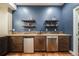 Basement bar area featuring floating shelves, tile backsplash and stainless-steel appliances at 2362 Spruce Way, Denver, CO 80238