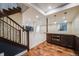 Basement area with a dark wood staircase, and a kitchen area featuring stainless steel appliances at 2362 Spruce Way, Denver, CO 80238