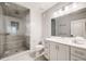 Modern bathroom featuring a glass-enclosed shower with rainfall showerhead and a vanity with ample storage at 2362 Spruce Way, Denver, CO 80238
