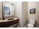 Elegant powder room with mosaic tile backsplash, dark wood vanity, and modern fixtures at 2362 Spruce Way, Denver, CO 80238