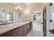 Bathroom featuring double sinks, a mosaic tile backsplash, and a black and white tiled floor at 2362 Spruce Way, Denver, CO 80238