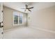 Spacious bedroom featuring a ceiling fan and large window with plantation shutters for natural light at 2362 Spruce Way, Denver, CO 80238