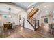 Open foyer with staircase, hardwood floors, and dining area with modern light fixtures at 2362 Spruce Way, Denver, CO 80238