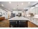 Modern kitchen featuring a large island with seating, pendant lighting, and stainless steel appliances at 2362 Spruce Way, Denver, CO 80238