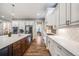 Modern kitchen with a white cabinets, stainless steel appliances, and hardwood floors at 2362 Spruce Way, Denver, CO 80238