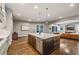 Bright kitchen with a large island, stainless steel appliances, and hardwood floors at 2362 Spruce Way, Denver, CO 80238