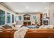 Spacious living room featuring a fireplace, built-in bookshelves, and abundant natural light at 2362 Spruce Way, Denver, CO 80238