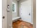 Mudroom featuring a built-in bench, white door, and tile flooring at 2362 Spruce Way, Denver, CO 80238
