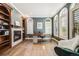 Home office with fireplace, built-in bookshelves, hardwood floors, and ample natural light at 2362 Spruce Way, Denver, CO 80238