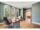 Office with arched windows, view of the backyard, and hardwood floors at 2362 Spruce Way, Denver, CO 80238