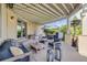 Inviting covered patio with stone grill, comfortable seating, and stylish lighting, perfect for outdoor relaxation and entertaining at 2362 Spruce Way, Denver, CO 80238