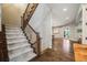 Staircase with carpeted treads, and dark wood railings at 2362 Spruce Way, Denver, CO 80238