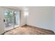 Bright bedroom features wood floors, a sliding glass door to a balcony, and ample natural light at 63 S Sable Blvd # E22, Aurora, CO 80012