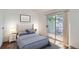 Stylized bedroom features wood floors, a sliding glass door to a balcony, and ample natural light at 63 S Sable Blvd # E22, Aurora, CO 80012