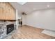 Open-concept living room with a stone fireplace, skylight, hardwood floors, and neutral paint at 63 S Sable Blvd # E22, Aurora, CO 80012