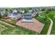 Aerial view of the home with a large deck and gravel yard surrounded by a wood fence at 9721 Marmot Ridge Cir, Littleton, CO 80125