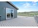 This extra-large deck has gray stained floor boards and white rails, overlooking a mountain view at 9721 Marmot Ridge Cir, Littleton, CO 80125