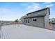 The backyard of this two-story home has a large deck and green vinyl siding at 9721 Marmot Ridge Cir, Littleton, CO 80125