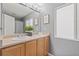 Bathroom with dual sinks, framed mirror, and a window for natural light at 9721 Marmot Ridge Cir, Littleton, CO 80125