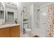 This full bathroom features a shower over tub, oak vanity, and built-in storage at 9721 Marmot Ridge Cir, Littleton, CO 80125