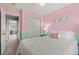 Bright bedroom showcases pastel walls, soft lighting, and closet access at 9721 Marmot Ridge Cir, Littleton, CO 80125