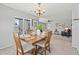The dining room features a square table with seating for four and a view of the living room at 9721 Marmot Ridge Cir, Littleton, CO 80125