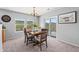 Dining room features natural light, a chandelier, and a sliding door to the outdoor patio at 9721 Marmot Ridge Cir, Littleton, CO 80125