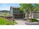 Charming two-story home with a spacious two-car garage, fenced yard, and beautiful landscaping at 9721 Marmot Ridge Cir, Littleton, CO 80125