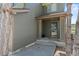 Inviting front porch with stylish columns, green door, and exterior walls at 9721 Marmot Ridge Cir, Littleton, CO 80125