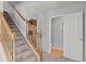 The stairway with carpeted steps and wood railings leads to a half bathroom and other rooms at 9721 Marmot Ridge Cir, Littleton, CO 80125
